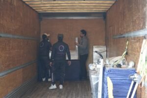 Moving ASAP crew carefully wrapping furniture for transport