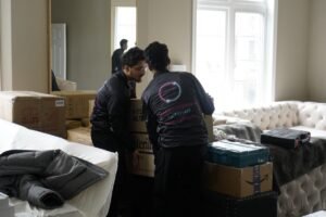 Movers protecting and wrapping furniture on moving day